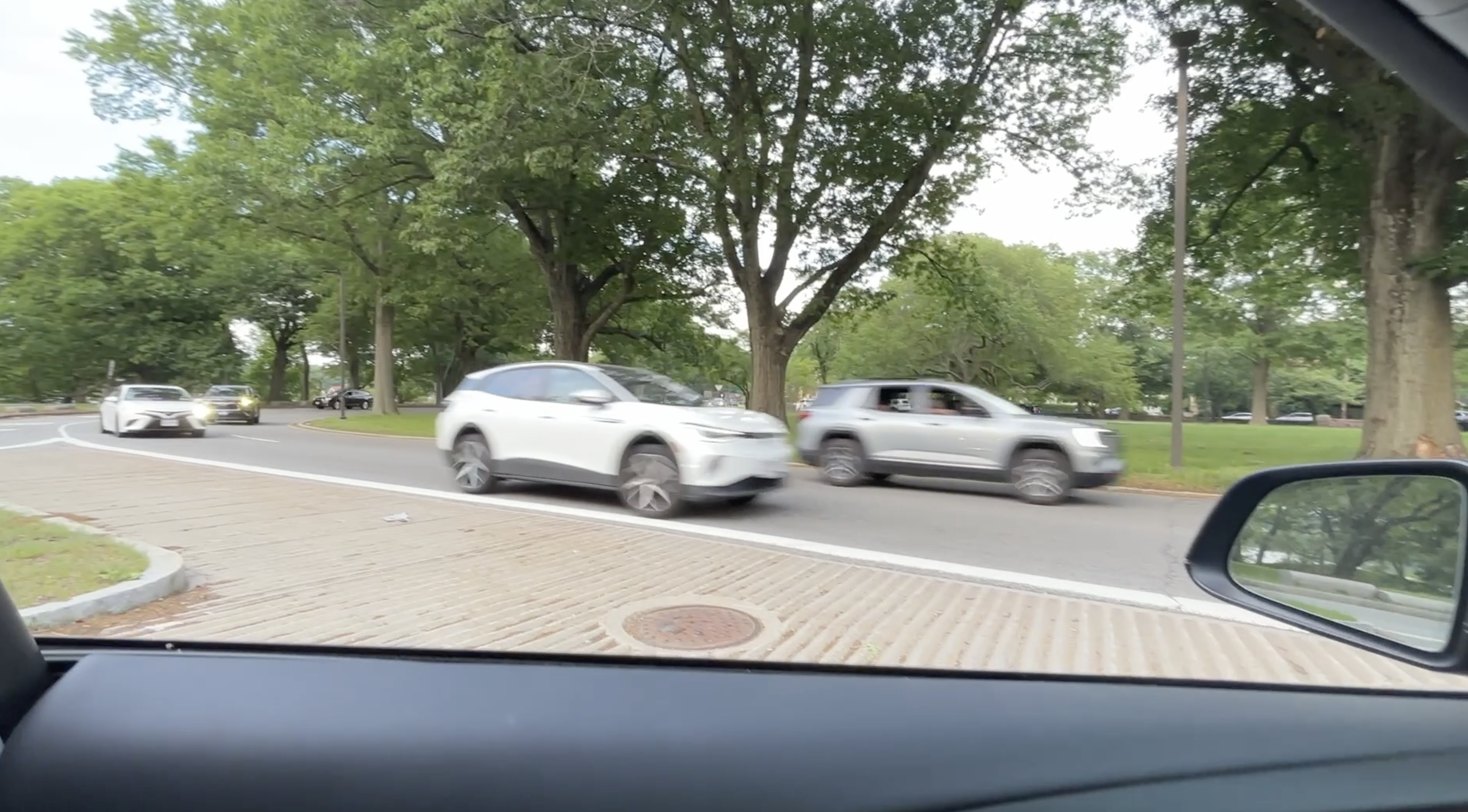 Autonomous driving on Jamaica Way Boston with Jamaica Pond in background